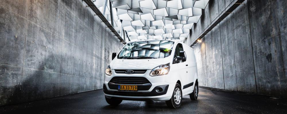 A white ford transit van being used for couriering