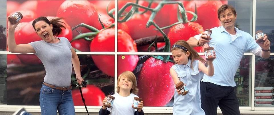 jim jams founder family jumping happy holding jars of chocolate spread