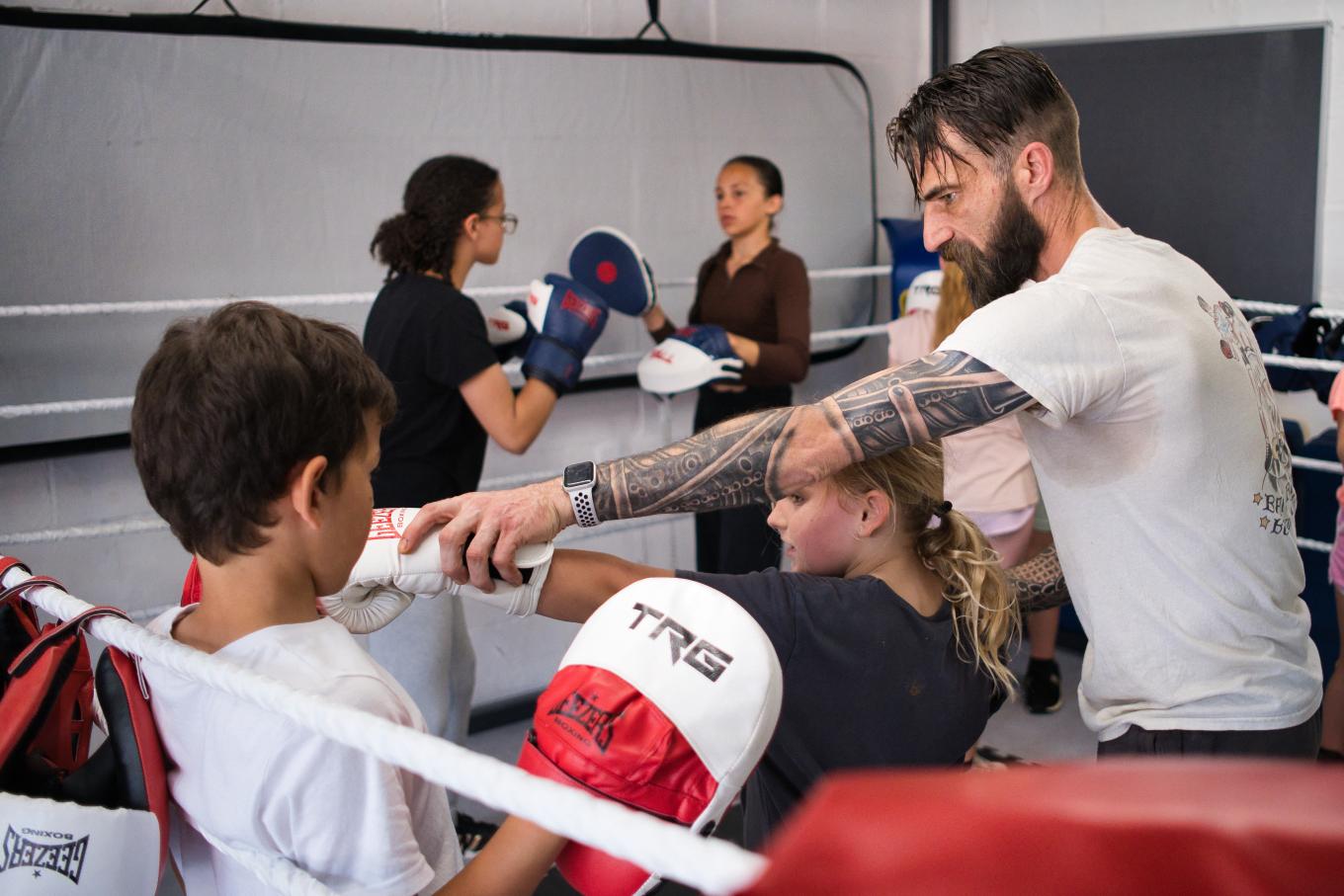 Jamie Parker, founder of Bang Bang Boxing teaching children to box inside a ring