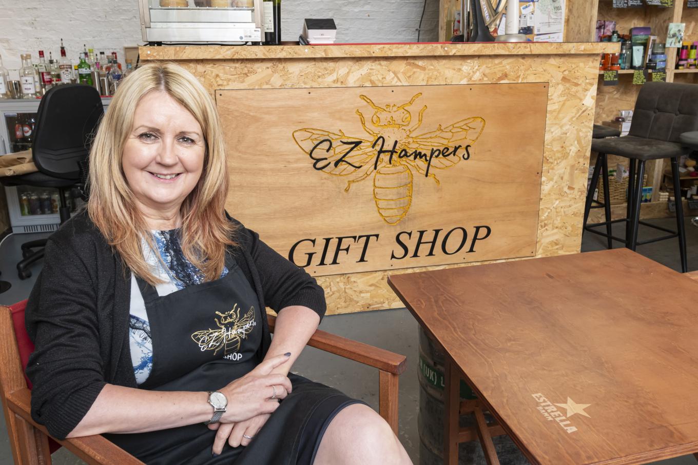 Owner of EZ Hampers sitting in her store