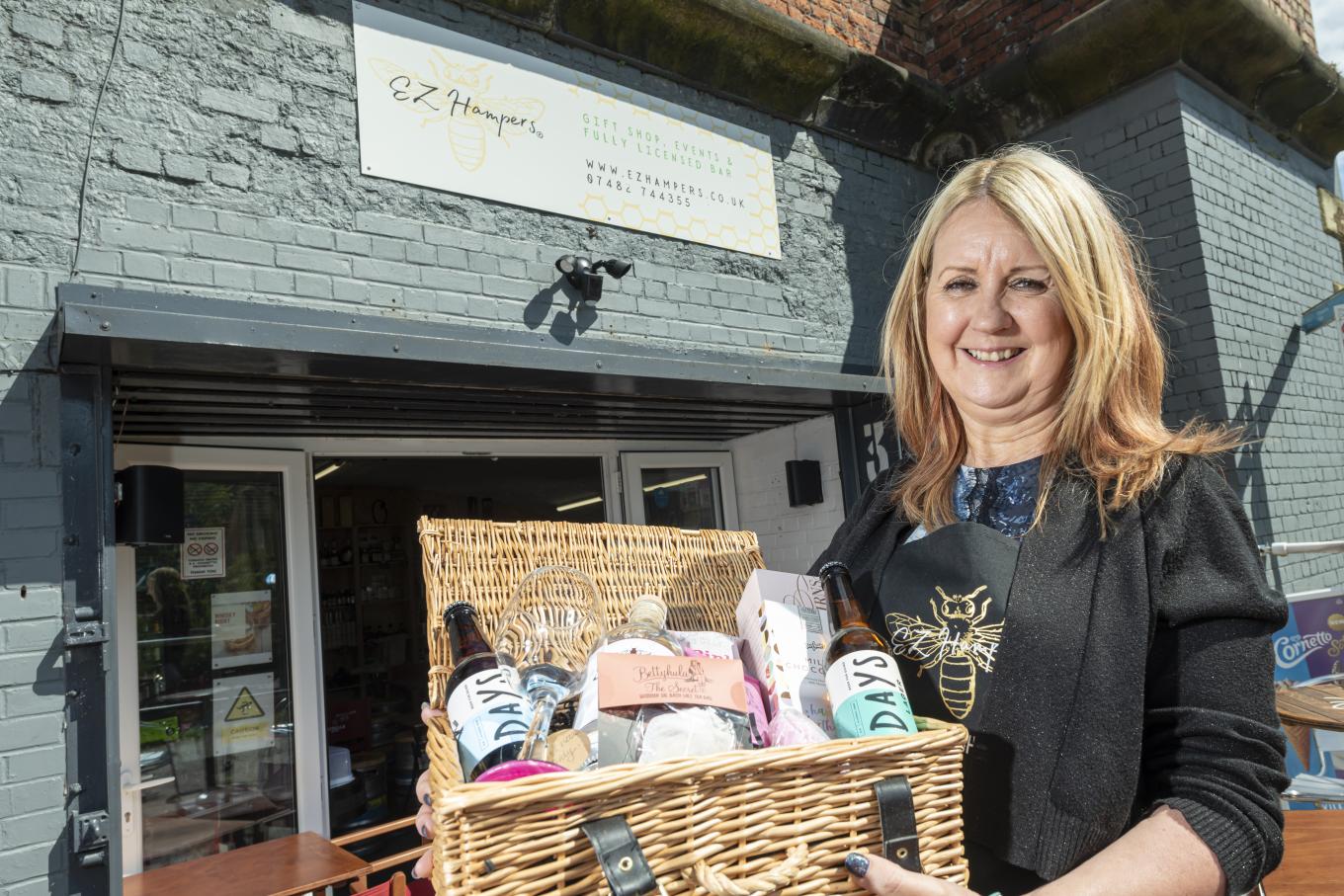 Lisa Storey, founder of EZ Hampers, holding a gift hamper