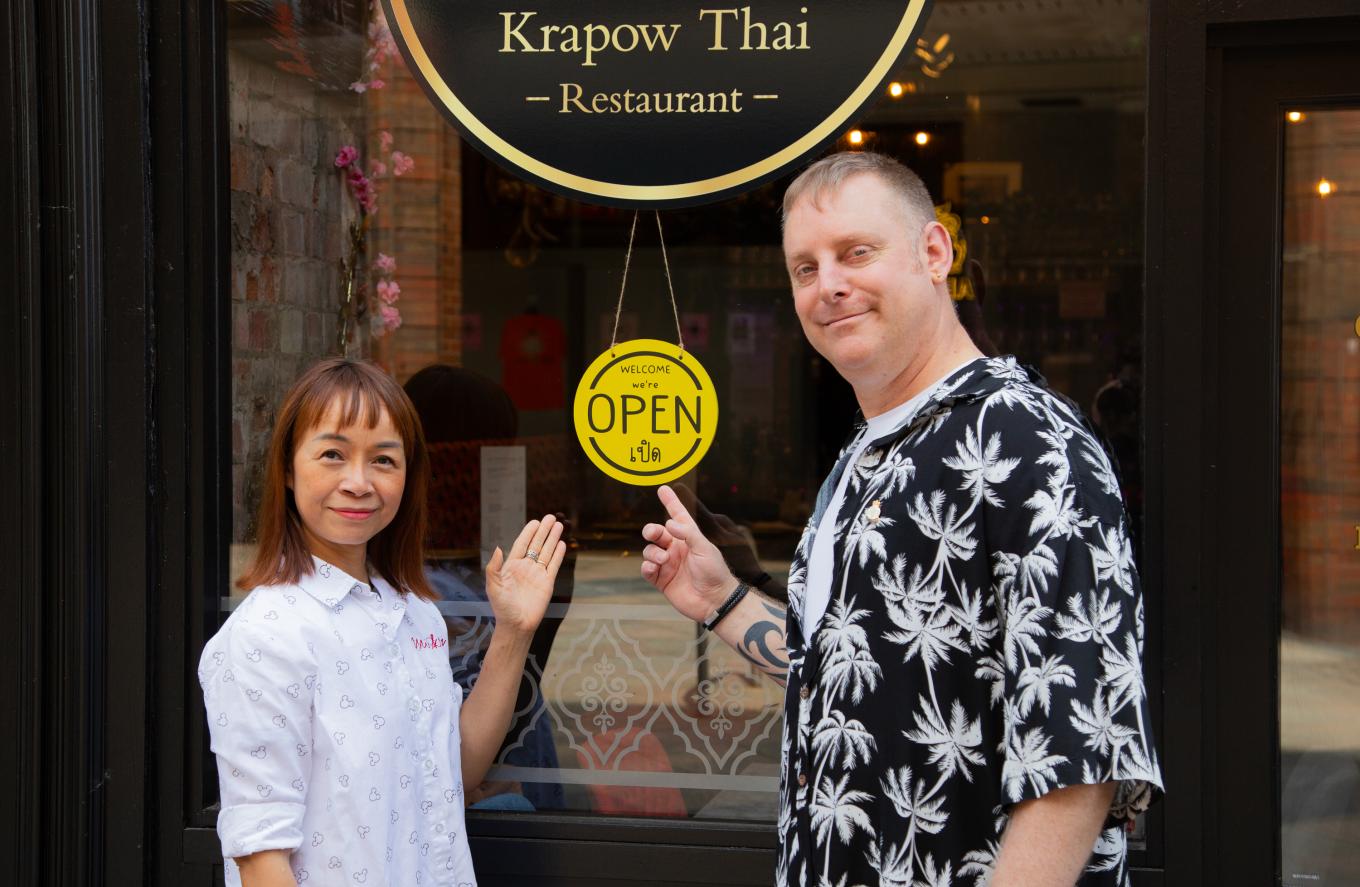 Business owners of Krapow Thai standing in front of their restaurant