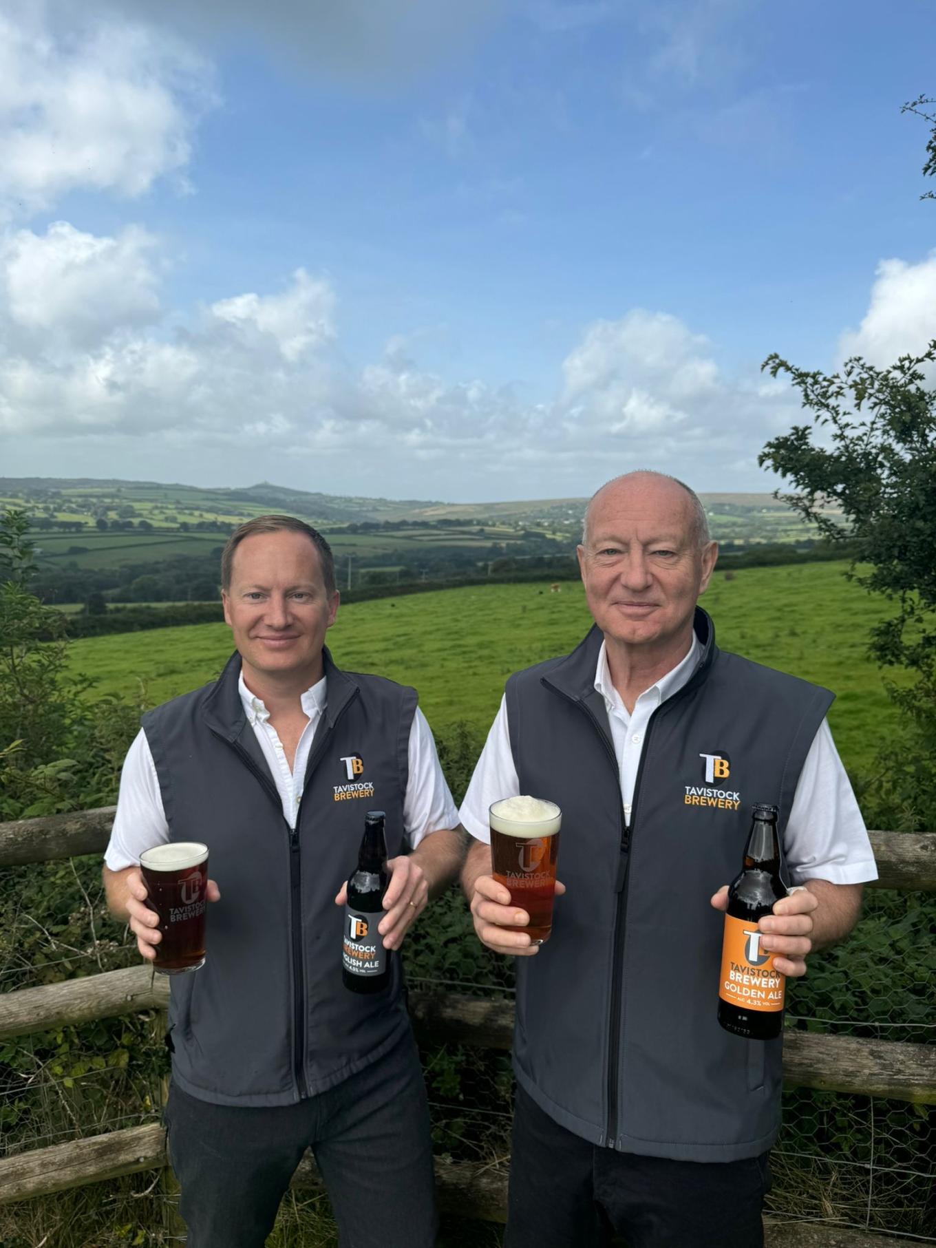 Two men standing with beer in their hands 