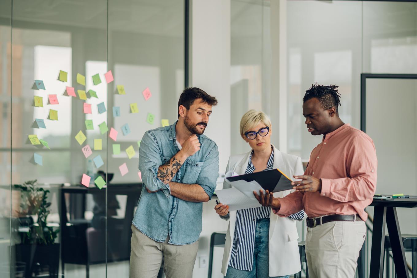 A brainstorming session in the office made up of two males and a female 