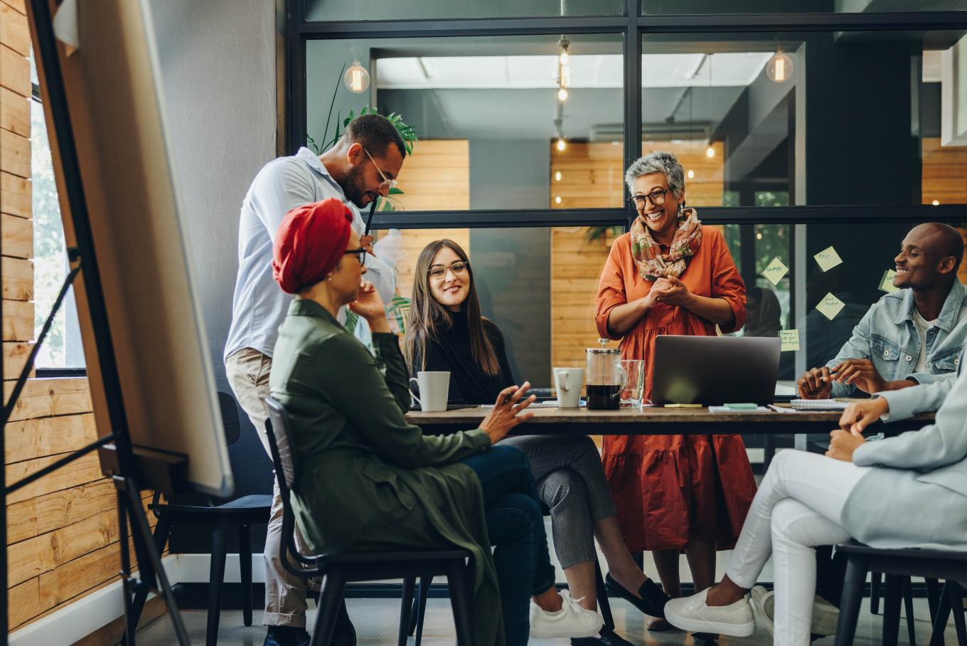 Group of people smiling in a meeting