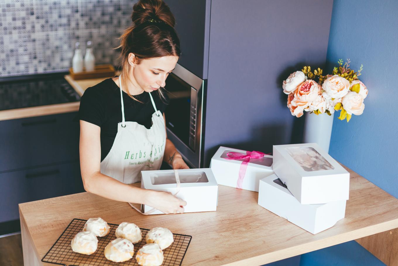 female cake baker packing cakes