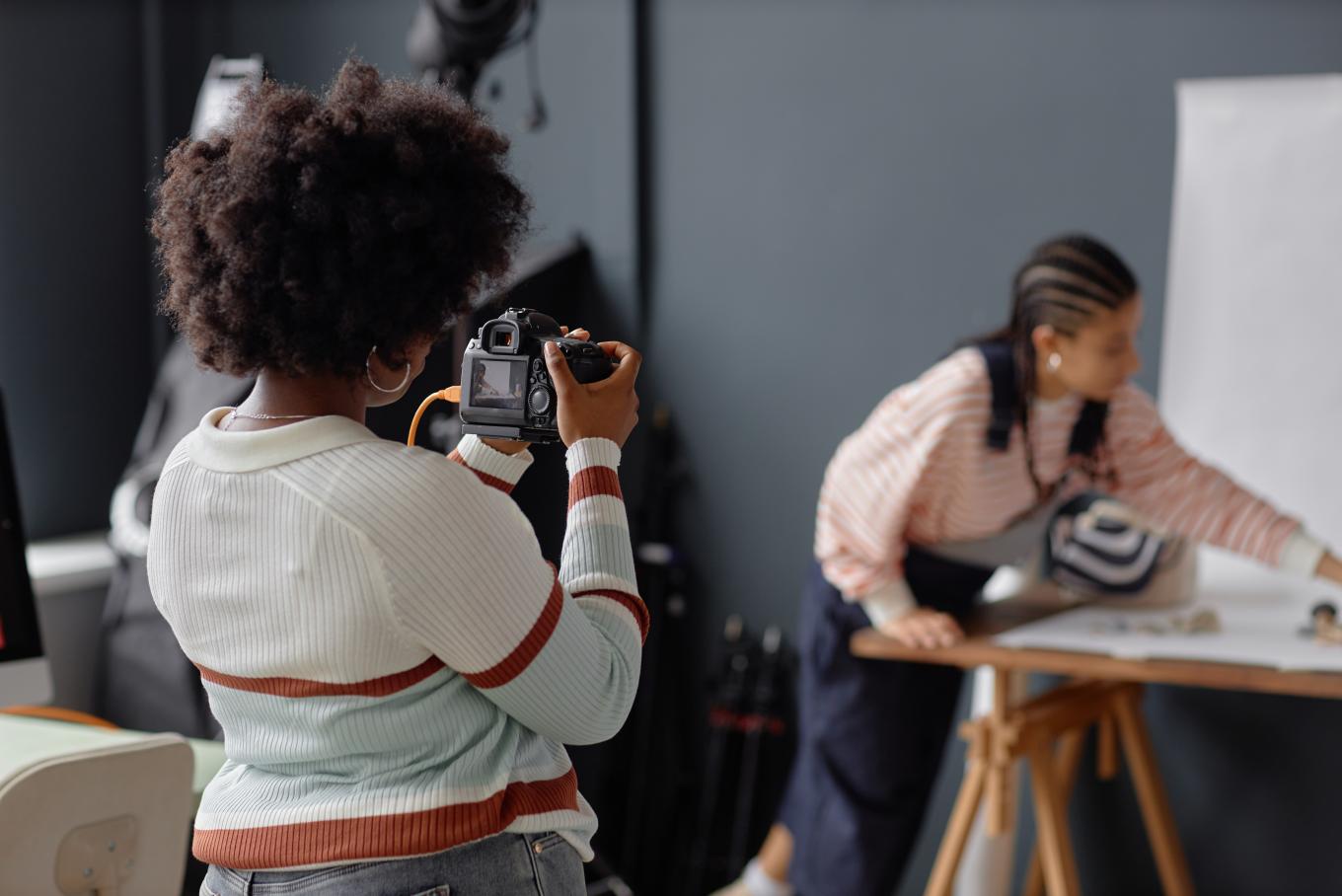 A female photographer taking a picture of her subject
