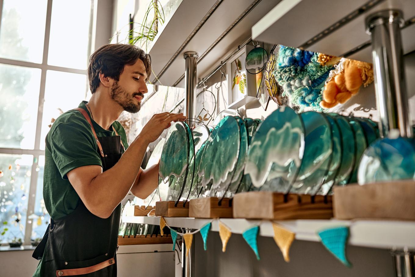 A craftsman putting products onto a store shelving unit